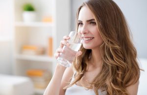 Woman drinking water and smiling