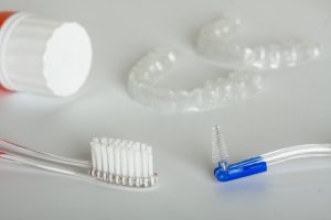 photo with a toothbrush, retainers, toothpaste and a proxabrush