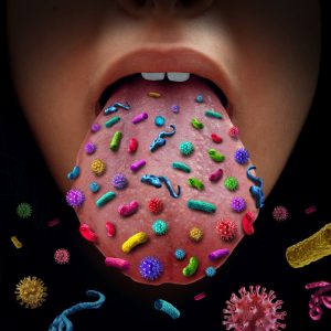 An image of a person's tongue that they are sticking out. Different types of bacteria have been added digitally to show that there is a ton of bacteria on the tongue.